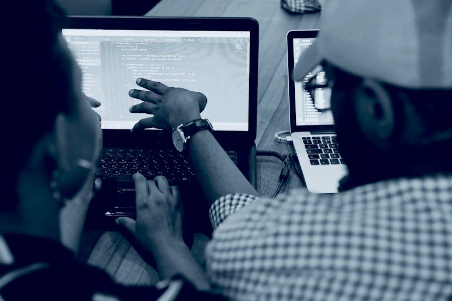 Developers reviewing code together on a laptop