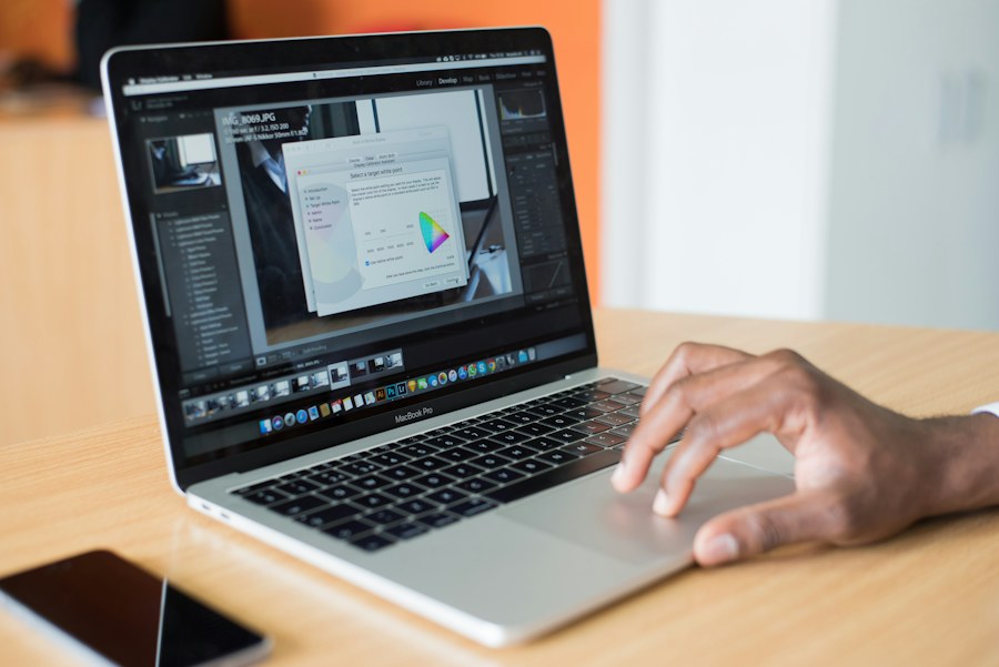 Hand using a laptop showing business software